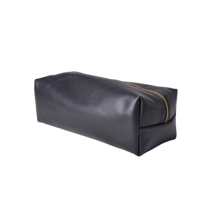 Black leather toiletry bag with gold zipper on a white background