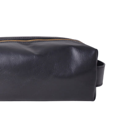 Close-up of a black leather pouch with a gold zipper, shown against a plain white background.
