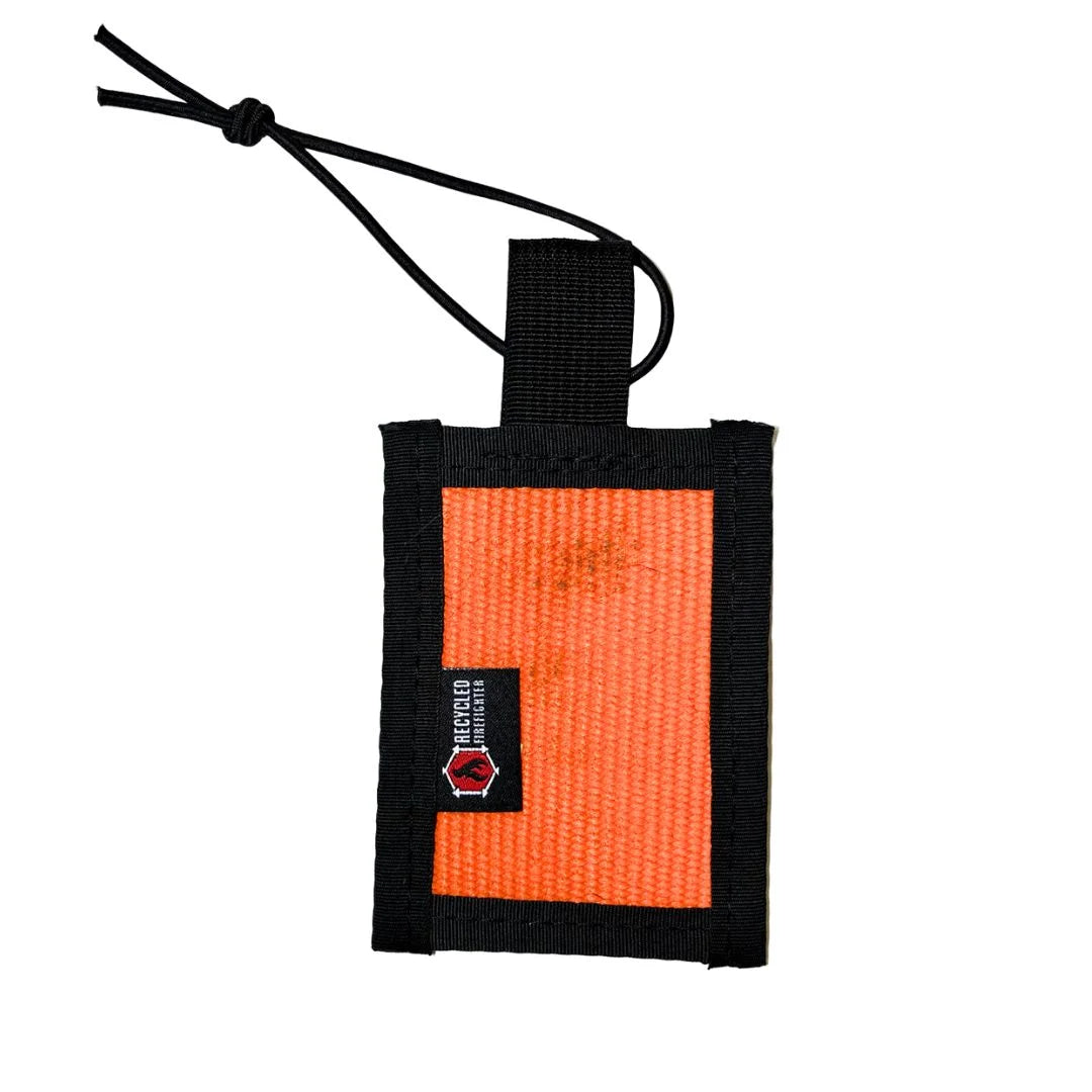 Recycled Firefighter firehose luggage tag in orange with black nylon binding, handmade in USA from decommissioned firehose