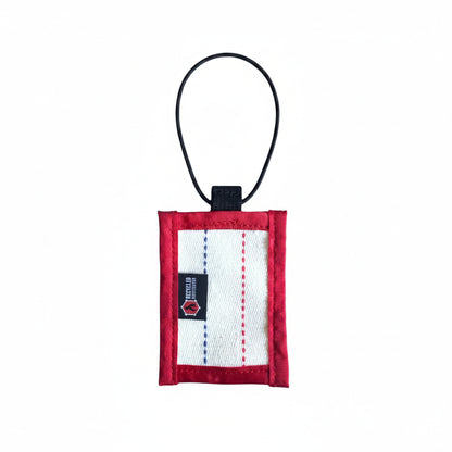 Small red and white pouch with a black strap on a white background