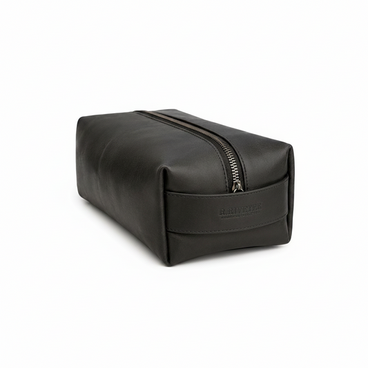 Black leather toiletry bag with a zipper on a white background