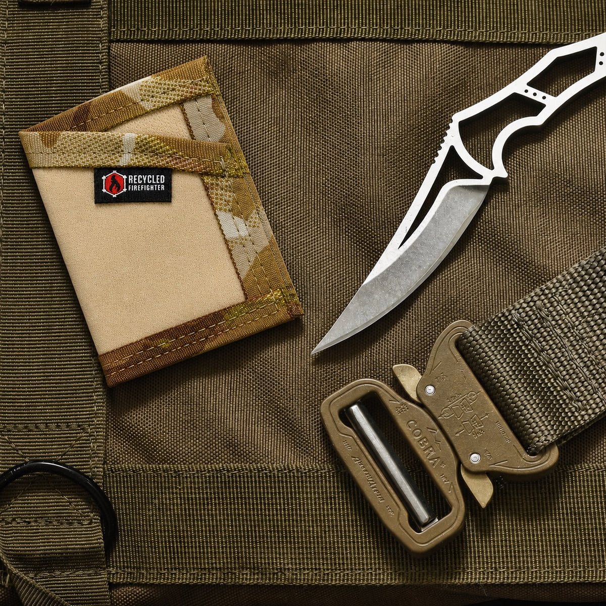 Tactical knife and pouch on a brown tactical bag with 'Recycled Infantry' branding.